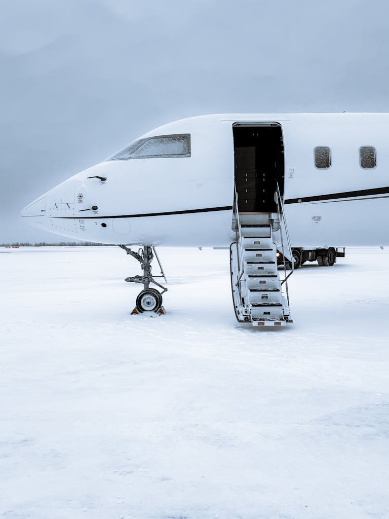 Private Jet with Open Stairs at a Snowy Airport